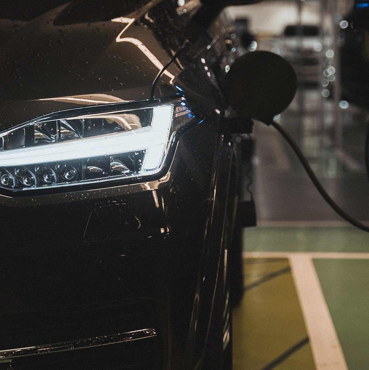 black car at EV charging station